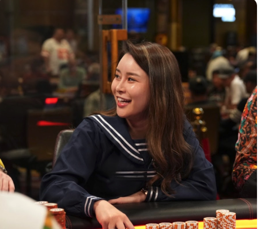 Sashimi smiling at a live poker table